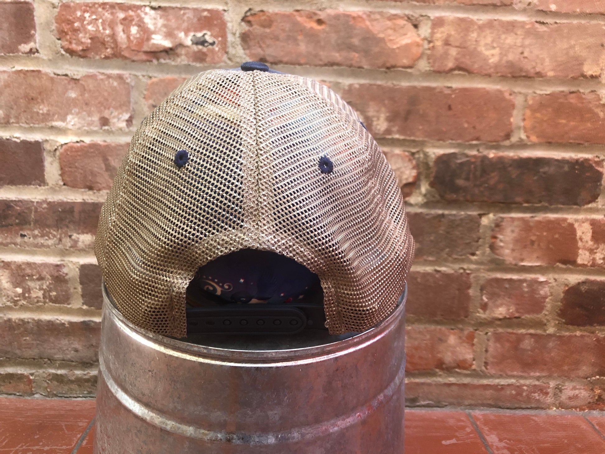 the back of a mesh hat with the Monadnock Conservancy logo on the front