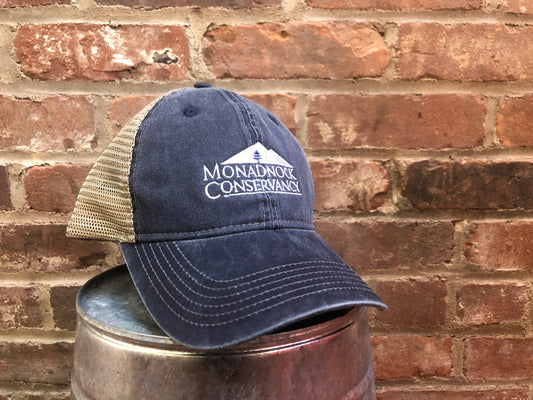 A hat with a mesh back and Monadnock Conservancy logo