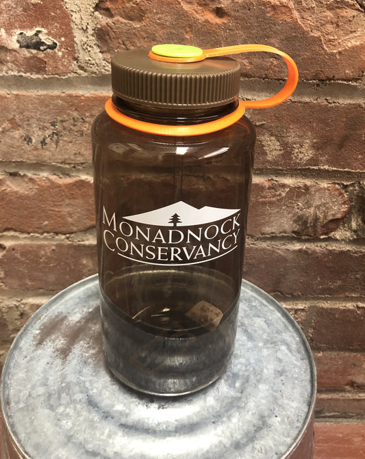 A Nalgene water bottle with Monadnock Conservancy's logo