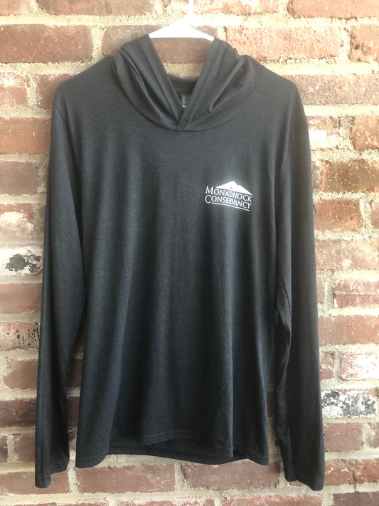 A black long sleeved t shirt with the Monadnock Conservancy logo
